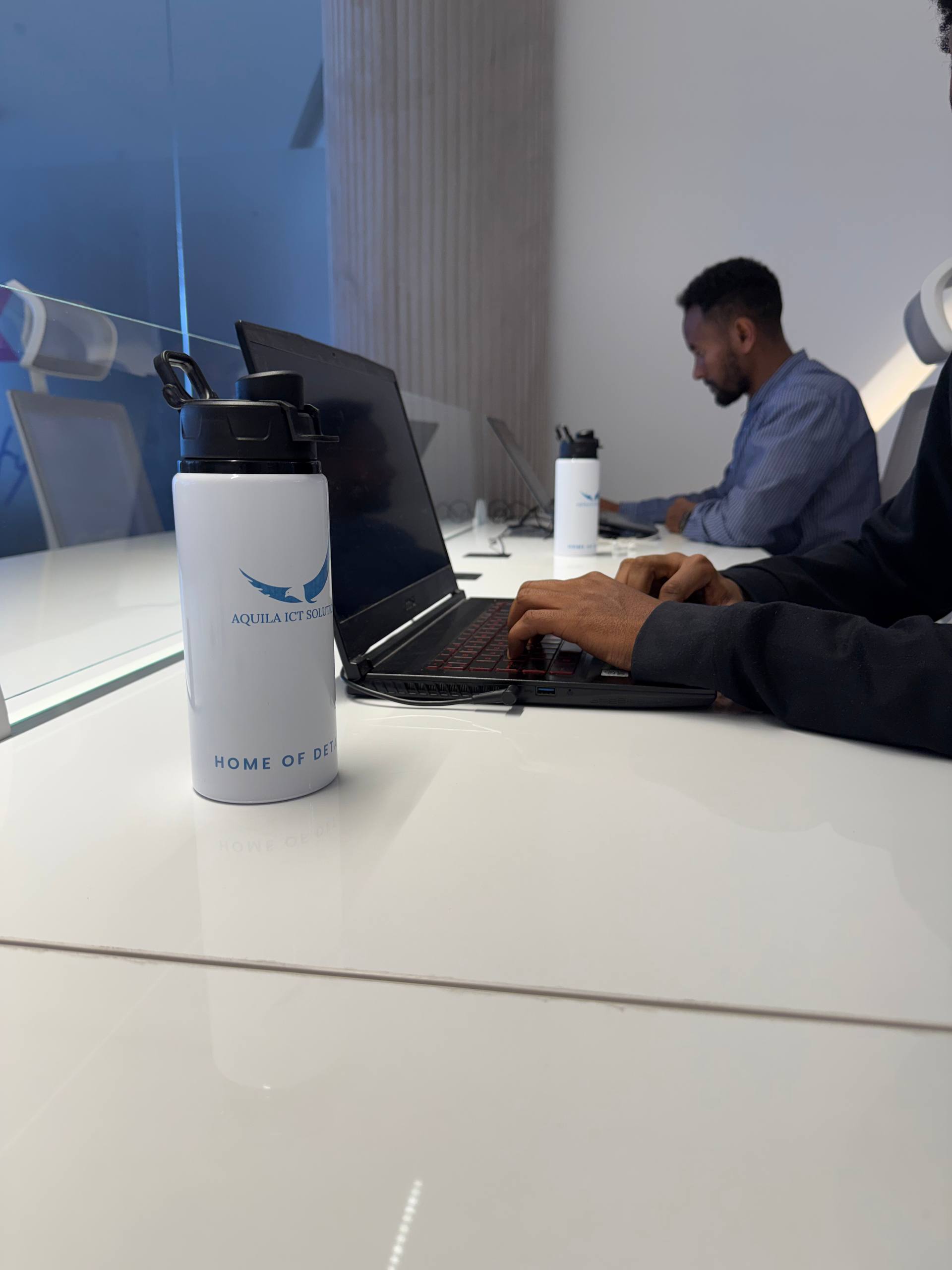 Developer at work with Aquila ICT branded merchandise